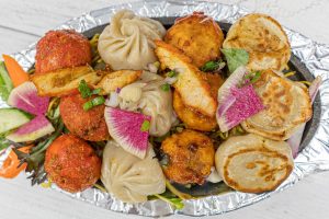 A platter of 4 different momo (dumplings). 3 Momo each. 12 Total Momo.