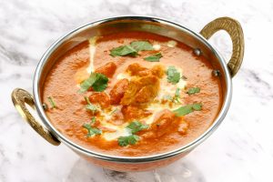 Butter Chicken in a traditional metal bowl