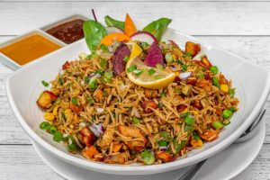 California Spicy Fried Rice topped with Lime Wedge and Herbs served with two sauces