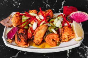 Tandoori Salmon Tikka on a white plate